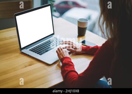 Anonymous female freelancer using computer in workplace Stock Photo