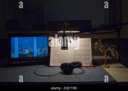 Professional condenser microphone with headphones  in recording studio interior. Stock Photo