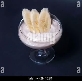 banana dessert in glass on black background