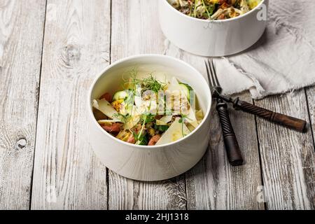 Delicious fish salad with lightly salted salmon, egg, cheese, fresh herbs and spicy mustard sauce. Prepared in the home kitchen. Delicious and healthy Stock Photo