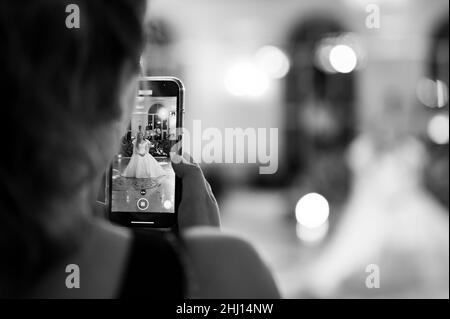 Dolyna, Ukraine June 27, 2021: the first wedding dance of the brides, dance on a mobile phone, the guest shoots the dance of the brides on a mobile ph Stock Photo