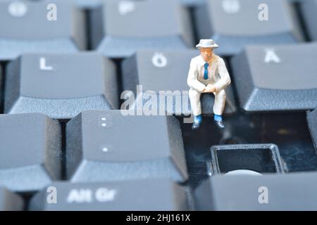 miniature you sit on a computer keyboard Stock Photo