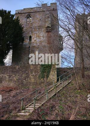 With St Nicholas Church in the background, The Marmion Tower with wooden steps leading down to the banks of the river Ure Stock Photo