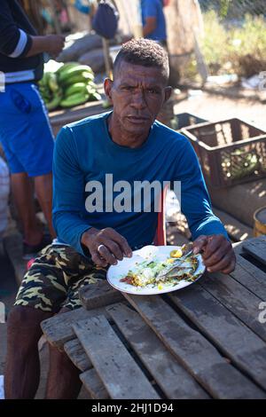 Portrait of a Afro Caribbean man having breakfast al fresco at Mercado Bazurto, Cartagena de Indias, Colombia. Stock Photo