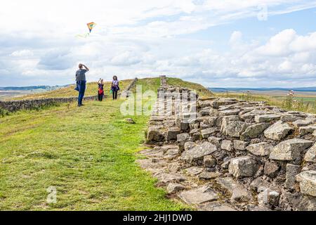 Flying a kite beside Hadrians Wall at Caw Gap, Shield on the Wall, Northumberland UK Stock Photo