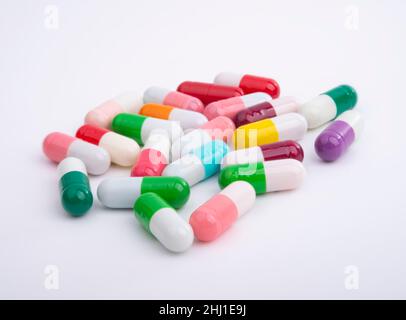 Different color pills on white background Stock Photo