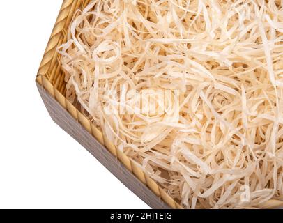 Sawdust in open box for packing gifts on the white Stock Photo
