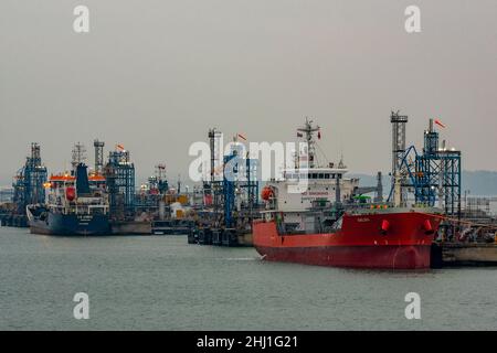 oil and gas tankers alongside the marine terminal at fawley petrochemical processing plant and refinery at the port of southampton docks uk. Stock Photo