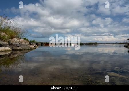 A blue sky with patchy clouds over a calm bay in the summertime. From the Swedish island Oland Stock Photo