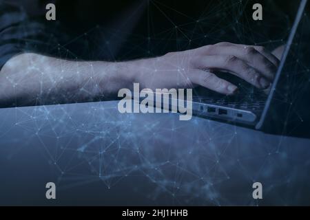 Hands at laptop with interconnectivity graphic overlay Stock Photo