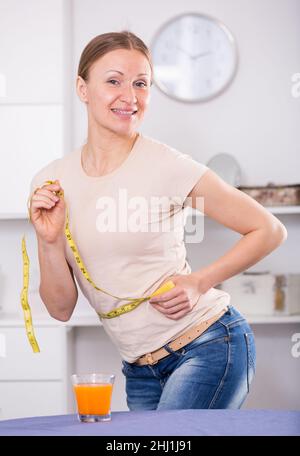 Woman controlling waistline Stock Photo
