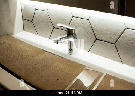 Newly installed bathroom faucet. Home renovations. Stock Photo