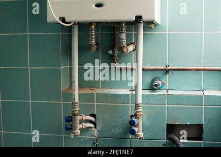 House gas heating boiler installed in a wall. Change the boiler. Home renovations. Stock Photo