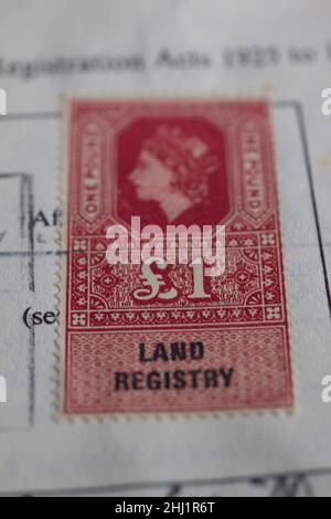 land registry, stamp duty land tax historic stamp with queen elizabeth 2 on one pound red stamp Stock Photo