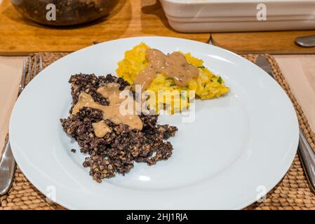 Traditional Scottish Burns Night supper dinner plate: haggis and clapshot (mashed potato and turnip or swede) with whisky sauce, Scotland Stock Photo