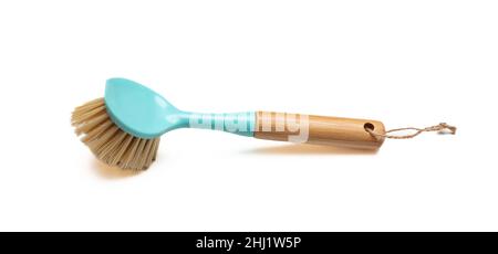 Dish washing brush isolated cutout on white background. Blue pastel dish brush with wooden handle. Kitchen equipment. Stock Photo