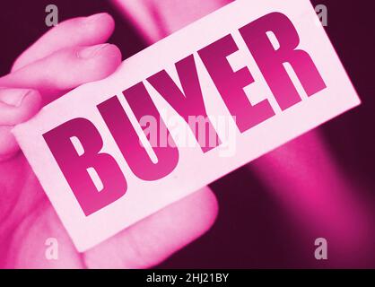 Buyer word on the card shown by a man. Customer business concept. Stock Photo