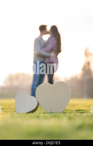 Couple Kissing Behind Heart Shape Stock Photo - Alamy