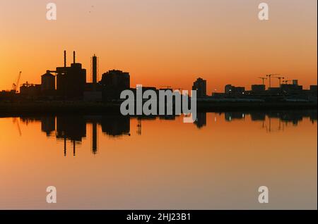 Royal Albert Dock, London Docklands, South East England, at sunset, looking south towards London City Airport and the Tate & Lyle industrial complex Stock Photo