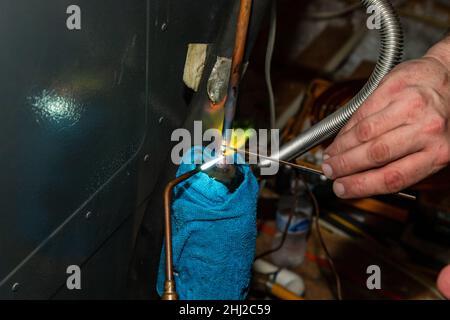 Air Conditioner Technician using a brazing torch to repair equipment Stock Photo