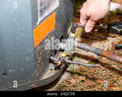 Technician closing valve on HVAC system Stock Photo