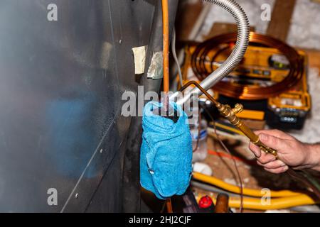 Air Conditioner Technician using a brazing torch to repair equipment Stock Photo