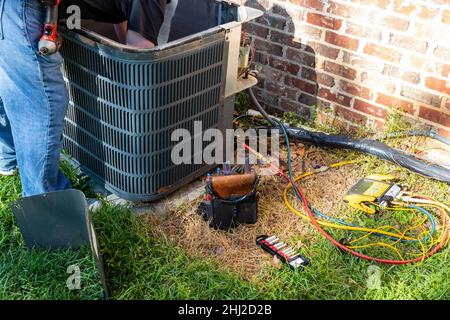 Air conditioner maintenance being performed Stock Photo