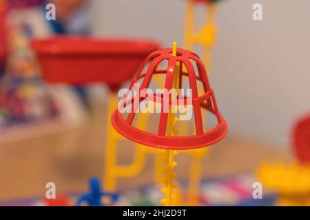 A close up view of the Red basket balanced on the yellow pole of the Mouse Trap. Stock Photo