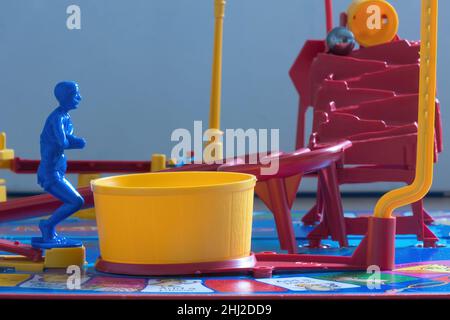 Close up of the Diver on Mouse Trap Board Game ready to dive into the yellow Pool which sets of the mouse trap.The buckets tips out the steel ball. Stock Photo