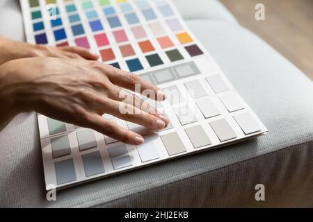 Female hands on paint swatches palette close up Stock Photo