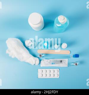 Medicines in different bottles with pills and  drugs on blue background. View from a top. Stock Photo