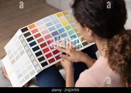 View over female shoulder holding pantone samples, close up Stock Photo
