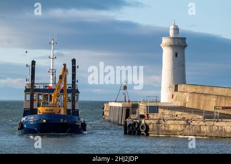 BUCKIE,MORAY, SCOTLAND - 23 JANUARY 2022: This is the Moray Council owned Dredger boat called Selkie arriving back at Buckie Harbour, Moray, Scotland Stock Photo