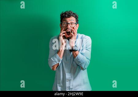 Surprised man in glasses, surprised young man, man with a surprised face, shocked man Stock Photo
