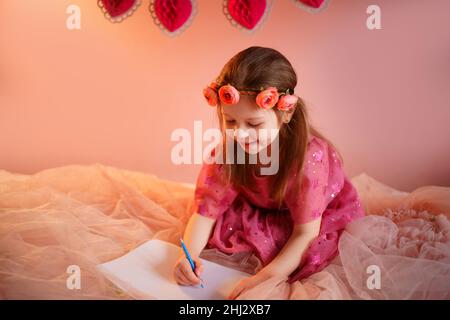 girl writes a valentine Stock Photo