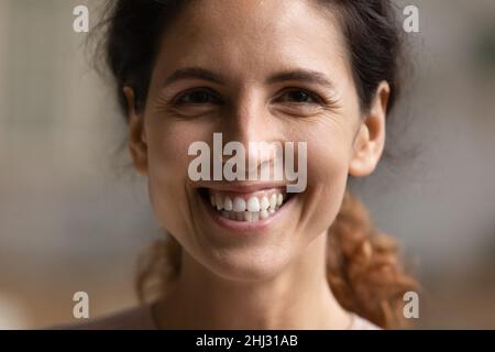 Closeup portrait of young Hispanic woman smiling looking at camera Stock Photo