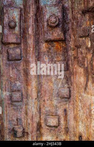 BACKGROUND TEXTURE - Old Rusty cast iron plate with bolts Stock Photo