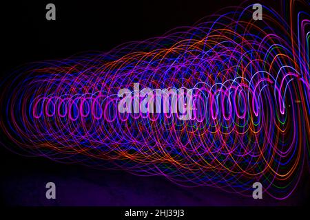 Multicolored spiral with light on a dark background. Stock Photo