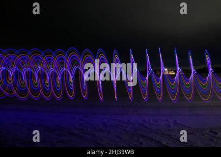 Multicolored spiral with light on a dark background. Stock Photo