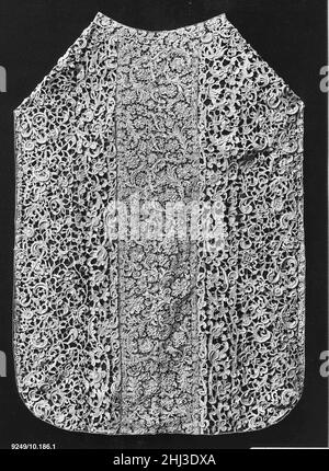 Chasuble of needle lace second half of 17th century Italian, Venice Close analysis reveals that the swath of lace covering this rare chasuble has actually been assembled from over a dozen different pieces of Venetian gros point, arranged to fit the Roman silhouette. Needle lacemaking emerged in Venice in the last decade of the fifteenth century, and its elaborate openwork patterns, defined by negative space, were unlike any textile that had come before. This technique developed out of cutwork, in which a woven linen foundation is traced with a pattern which is then cut out, and stitches are wo Stock Photo