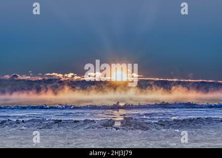 Sunrise on iceberg with fog coming off of lake Stock Photo