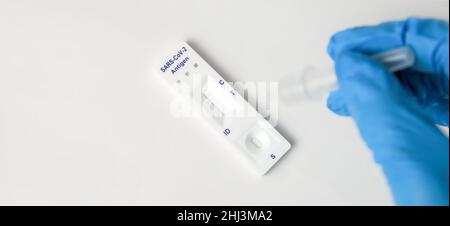 Man makes a covid-19 antigen pcr test macro. The test showed a positive result. Stock Photo