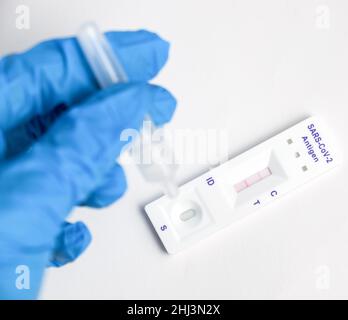 Man makes a covid-19 antigen pcr test macro. The test showed a positive result Stock Photo