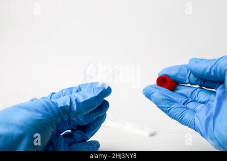 Man makes a covid-19 antigen pcr test macro. The test showed a positive result. Stock Photo