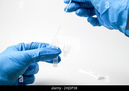 Man makes a covid-19 antigen pcr test macro. The test showed a positive result. Stock Photo