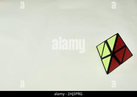 rubik's cube pyramorphix, solved on white background with copy space 2 Stock Photo