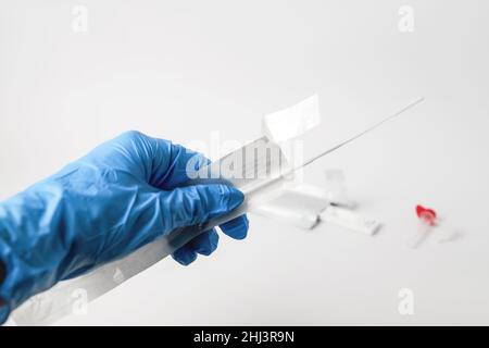 Man makes a covid-19 antigen pcr test macro. The test showed a positive result. Stock Photo