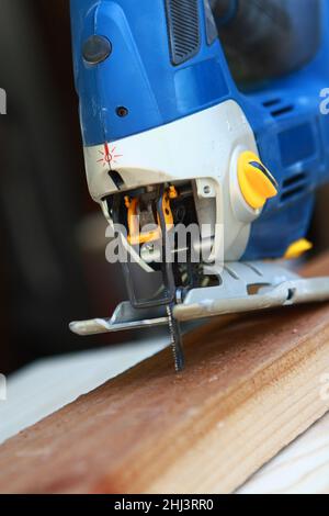 https://l450v.alamy.com/450v/2hj3rr0/tools-of-the-trade-craftsman-with-a-battery-operated-saw-wood-cutter-getting-that-wood-work-done-2hj3rr0.jpg