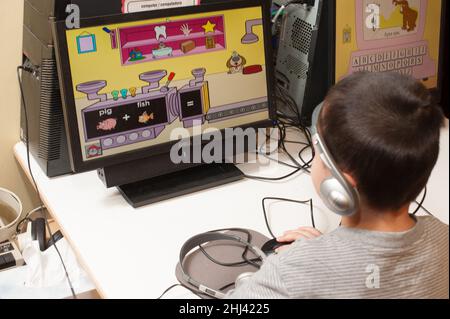 Education Preschool 3-4 year olds boy using computer to play educational game Stock Photo