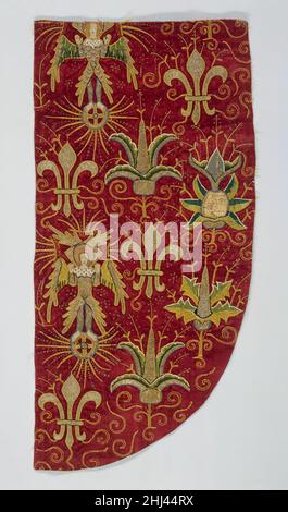 Opus Anglicanum (Chasuble) late 15th century British This fragment of "opus anglicanum" ("English work," as it was called in medieval inventories) is remarkable for the richness of its design and its superb state of preservation. The decoration consists of two cherubim, each atop a wheel from which rays of light emanate; four fleurs-de-lis; and four thistles in three different designs, each motif distributed along a vertical axis. These elements, all embroidered in vibrantly colored silk and silver-gilt threads, are appliquéd onto the red velvet foundation, on which the scrolls and other desig Stock Photo